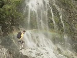 Couple at picturesque waterfall Stock Footage