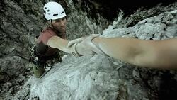 HD: Climber Reaching For A Helping Hand Stock Footage