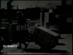 1940: US TRADE SANCTIONS ON JAPAN: Angled WS Mitsubishi warehouse, Japanese workers moving boxes & bales w/ handcart on export docks, single horse cart loaded w/ boxes moving slowly at dock, ships BG. Instructional Video