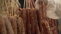 A grocery stocker hangs sausages at a store in Tianjin, China. Stock Footage