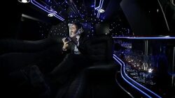 Proud celebrity in back of limousine shows off awards trophy to paparazzi at awards show Stock Footage
