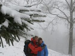 Pull focus of father and son hiking/using compass in snowstorm Stock Footage
