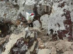 WS Miner climbing the Ijen volcano crater carrying sulfur / Ijen, Java, Indonesia Stock Footage