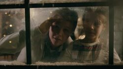 Kids looking out of the snowy window Stock Footage