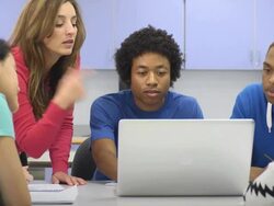 Instructor Assists Students with Laptop Computer Stock Footage