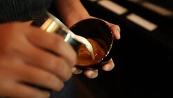 Tutorial barista making art latte, slow motion Stock Footage