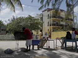 Man grills on the beach in Belize Stock Footage