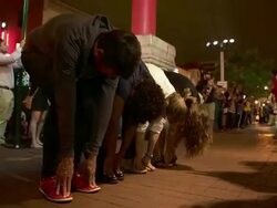 Street performers in the Chinatown area of Washington DC, Man jumping over group of people Stock Footage