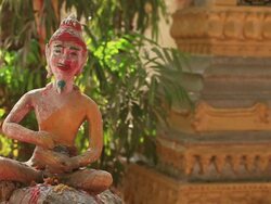 MS SLO MO Head of droll mustached buddhist statue  / Vientiane, Laos Stock Footage