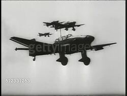 1939: NAZI WWII PROPAGANDA: TU CU Nose cone of spinning airplane propeller. TRACKING Luftwaffe Junkers (JU-87) taking off, Messerschmitts taking off on field. AERIAL WS Junkers (JU-87) dive bomber airplanes in flight. Instructional Video