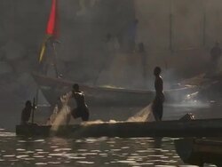 MS Pyrogue with fishermen dropping their nets in water with smoke / Lagos, Nigeria Stock Footage