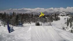 Snowboarder jumps in snow park Stock Footage