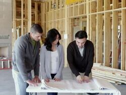 MS PAN Architect discussing  blueprints with his clients / Santa Fe, New Mexico, United States  Stock Footage