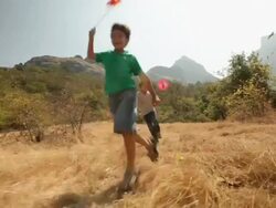 Group of kids playing with paper windmill in the forest Stock Footage