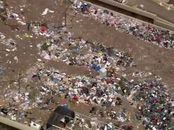 Aerial piles of debris and trash outside the Louisiana Superdome / zoom out roof / New Orleans, Louisiana Stock Footage