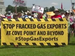 Anti-Fracking protesters hold up signs in front of the US Capitol Building Stock Footage
