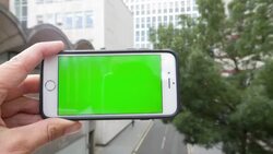 Man pressing a smartphone with a green screen Stock Footage