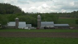 Wisconsin dairy farm under cloudy skys Stock Footage