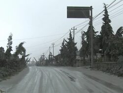 Road coated in thick layer of volcanic ash mud in village below Merapi volcano after eruption; Indonesia. 7 November 2010 / AUDIO Stock Footage