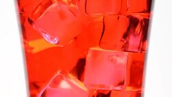 ice in  red water glass Stock Footage