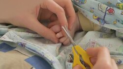 Cutting of child toenails Stock Footage
