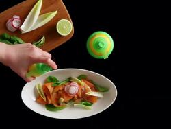 MS Hand setting plate of salmon salad and spraying lemon water on it / Seoul, South Korea Stock Footage
