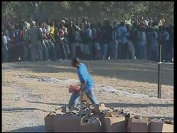 Food aid being distributed near tent city at golf course News Clip