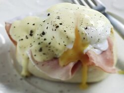  CU PAN Shot of Poached egg and ham on muffin / London, United Kingdom  Stock Footage