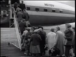 B/W 1961 REAR VIEW East German refugees boarding airplane / beginning of Berlin Wall / West Germany Stock Footage