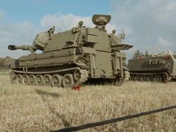 HMMWV and tanks in summer field Stock Footage