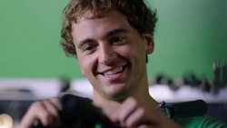 Bike mechanic smiles and talks with boss while making adjustments to bicycle Stock Footage