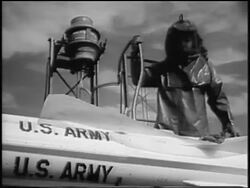 B/W 1955 person in protective clothing fuelling Nike missile outdoors / near Seattle, WA / newsreel Stock Footage