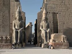 SEATED COLOSSI OF RAMSES AND OBELISK AT LUXOR TEMPLE Stock Footage
