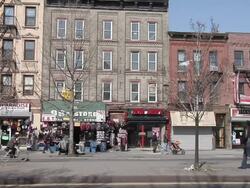 WS collection of shops along local street in Harlem / New York, United States Stock Footage