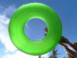 Slow motion low angle wide shot underwater view of senior man diving through inner tube floating in swimming pool Stock Footage