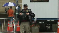 Police stopping cars at security checkpoint News Clip