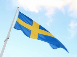 Swedish Flag Flying in the wind Zoom Out Stock Footage