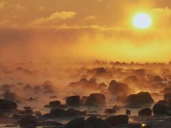 WS Arctic landscape on shore of hudson bay ice and snow blowing golden light / Churchill, Manitoba, Canada Stock Footage