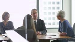 MS Mature male business executive leading project discussion during team meeting in office conference room Stock Footage
