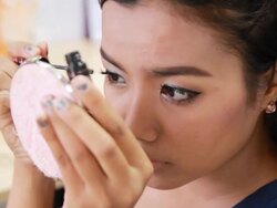 Asian Woman putting on mascara, closeup Stock Footage