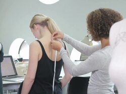 Fashion Designer measuring model in studio Stock Footage