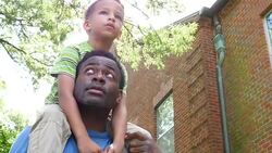 MS LA Young boy riding on fathers shoulders on summer afternoon Stock Footage