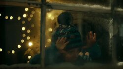 Boy spying on Santa-Claus distributing presents under christmas tree Stock Footage