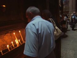 WS View of burning candles, priests, and tourists inside Church of Holy Sepulchre / Jerusalem, Jerusalem, Israel Stock Footage