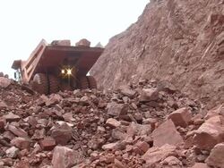 MS Truck pitching stone at quarry / Taben-Rodt, Rhineland-Palatinate, Germany Stock Footage