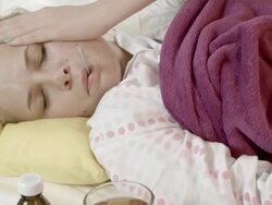 Woman Checking Her Temperature in Bed Stock Footage