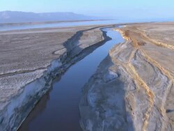 Aerial river flowing in to the Dead Sea in the Judea Desert, Israel Stock Footage