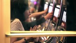 young woman playing slots in Vegas casino hits jackpot, celebrates with friends Stock Footage