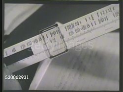 1935: CARBON LAB: ** VS Carbon chemist at desk reading book, using slide ruler. VS Various chemists in lab testing boiling alcohol in test tube, steam rising from container, placing jar 'Ethylene Glycol' on shelf, scientist looking at liquid in tube. Instructional Video
