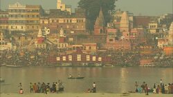 Bathers wade in a river in India. Stock Footage